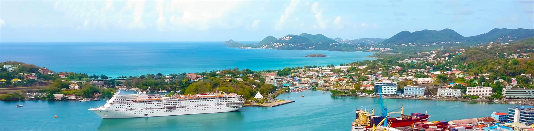 Cruise ship docked at a lush island port in the Caribbean Sea, St. Lucia